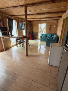 a living room with a table and a couch at Turismo Los Carbooneros de Pugueñun in Ancud