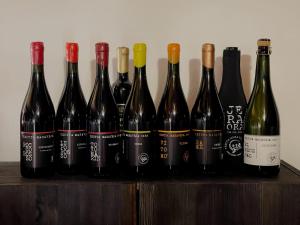 a row of wine bottles sitting on a wooden shelf at Tenuta Maraveja 1462 in Brendola +11 photos