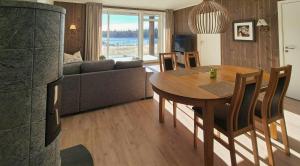 a living room with a table and a couch at Flat With Lake View In Sjusjøen in Sjusjøen