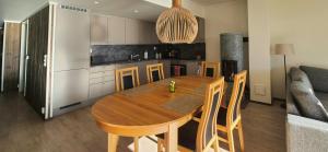 a kitchen with a wooden table in a room at Flat With Lake View In Sjusjøen in Sjusjøen