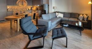 a living room with a couch and a table at Flat With Lake View In Sjusjøen in Sjusjøen