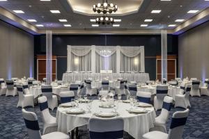 a banquet hall with white tables and white chairs at Courtyard Fargo Moorhead, MN in Moorhead +34 photos