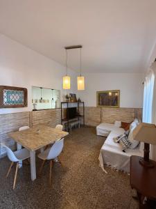 a living room with a table and a couch at Elportal in Alta Gracia