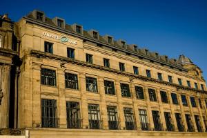 a large building with a sign on top of it at Motel One Edinburgh-Princes in Edinburgh +33 photos