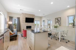 a kitchen and living room with a table and a fireplace at Contemporary Dual-Unit 2BR Downtown Branson - Free Tickets Included - LOFT in Branson