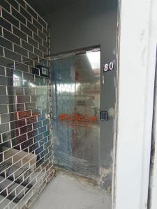 a glass door in a brick walled building at Vila do Chaves Casa da Popis 23 in Itajaí +9 photos