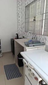 a kitchen with a sink and a counter top at Kit 400mts da praia in Bertioga