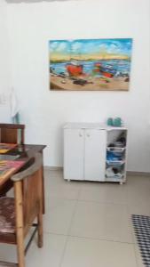 a room with a desk and a painting on the wall at Kit 400mts da praia in Bertioga