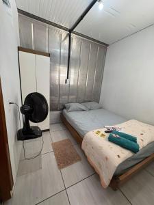 a room with two beds and a fan in it at Vila do Chaves Bruxa do 71 in Itajaí