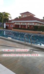 a swimming pool with a sign that reads water uptake was a large swamp free at Noah Bed&Breakfast 3 Private Room NEWHOME Quiet Place to Stay 14 Minutes to PPS Airport in Puerto Princesa City