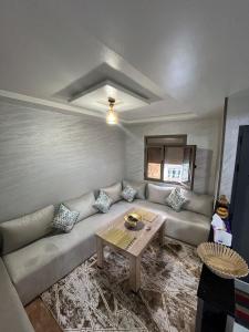 a living room with a couch and a table at yallah surf house in Taghazout