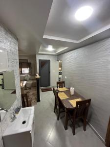 a kitchen and dining room with a table and a sink at yallah surf house in Taghazout +31 photos