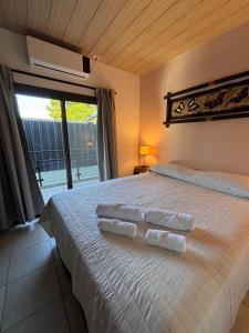 a bedroom with a bed with three towels on it at Departamentos Boutique Misiones in Puerto Iguazú +134 photos