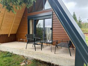 a patio with chairs and a table in front of a house at Vila Mia in Žabljak