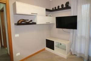a living room with a flat screen tv on a wall at HOUSE GARDEN MILANO -Pet Friendly, Giardino Chiuso in Trezzano sul Naviglio +35 photos