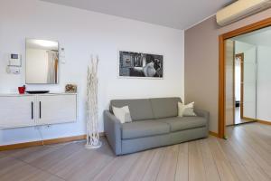 a living room with a couch and a mirror at HOUSE GARDEN MILANO -Pet Friendly, Giardino Chiuso in Trezzano sul Naviglio