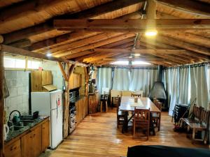 a kitchen and dining room with a table and chairs at Quincho Cabaña Las Marias in Ciudad Lujan de Cuyo +20 photos