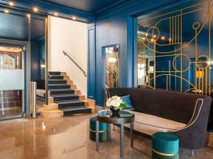 a living room with a couch and a table at Hotel Plaza Biarritz Plage - Handwritten Collection in Biarritz