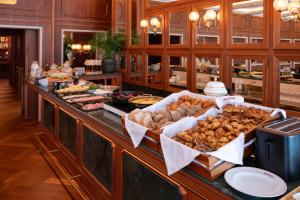 a buffet line with many different types of food at 1904 Benfica Hotel FLH Hotels in Lisbon