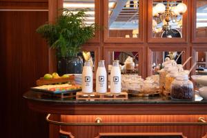 a buffet with drinks and food on a table at 1904 Benfica Hotel FLH Hotels in Lisbon