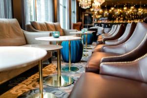 a row of tables and chairs in a restaurant at Motel One Berlin-Bellevue in Berlin