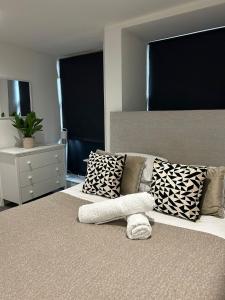 a bedroom with a large bed with pillows on it at Studio 3 - Eign St Hereford in Hereford