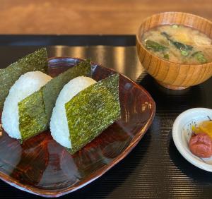 a plate of food with bread and a bowl of soup at 春日旅館-Kasuga Ryokan- in Nabari