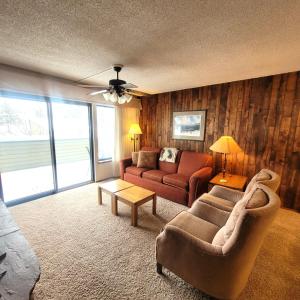 a living room with two couches and a table at Pines at Meadow Ridge in Fraser