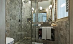 a bathroom with a shower and a toilet and a sink at Hotel Azimut in Sveti Stefan