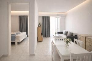 a white living room with a couch and a table at Casa al' Tati Apartments in Ialysos