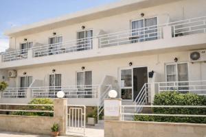 a white building with white balconies on it at Casa al' Tati Apartments in Ialysos