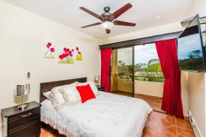 a bedroom with a bed and a ceiling fan at Coco Sunset Hills 52 in Coco +42 photos