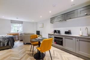 a kitchen and living room with a table and chairs at Rock Mill - Stunning Studio Apartment in Stony Middleton
