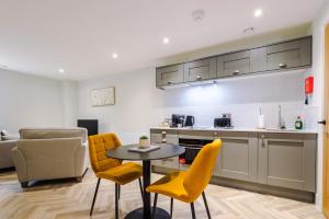 a kitchen and living room with a table and chairs at Rock Mill - Stunning Studio Apartment in Stony Middleton