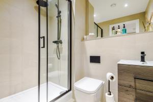 a bathroom with a shower and a toilet and a sink at Rock Mill - Stunning Studio Apartment in Stony Middleton