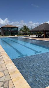 a large swimming pool with a building in the background at Carnaval 2026 in Tamandaré