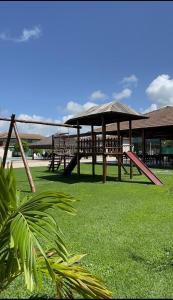 a group of picnic tables in a field of grass at Carnaval 2026 in Tamandaré
