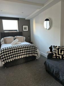 a bedroom with a bed and a window and a chair at Studio 5 - Eign St Hereford in Hereford