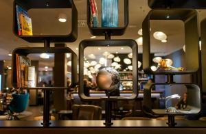 a display of mirrors with a ball in the middle at Motel One Frankfurt-Airport in Frankfurt