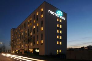 a hotel with a sign on the side of a building at Motel One Frankfurt-Airport in Frankfurt