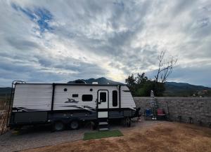 a white trailer parked next to a stone wall at Glamping in Pueblo Magico Alamos Sonora in Álamos