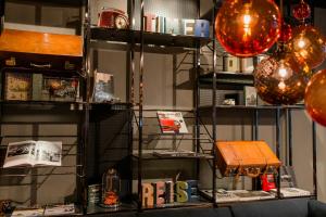 a shelf with books and a bag on it at Motel One Frankfurt-East Side in Frankfurt