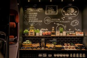 a bakery with a display of food on a wall at Motel One Frankfurt-East Side in Frankfurt