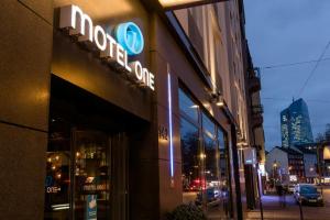 a store with a sign on the side of a building at Motel One Frankfurt-East Side in Frankfurt