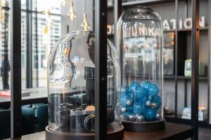 two glass cloclutes with blue balls in them on a table at Motel One Berlin-Spittelmarkt in Berlin