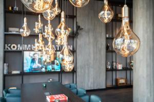 a room with chandeliers and a table and chairs at Motel One Berlin-Spittelmarkt in Berlin