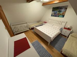 a small bedroom with a bed and a chair at Chalúpka pod Rozsutcom in Zázrivá