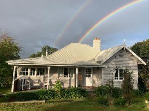 a rainbow over a house with at Cobargo ButterHaus in Cobargo +14 photos