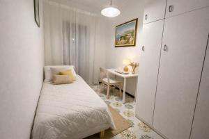 a small bedroom with a bed and a desk at Sorrento Life 1 in Sant'Agnello