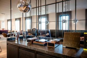a lobby with a counter with at Motel One Berlin-Potsdamer Platz in Berlin